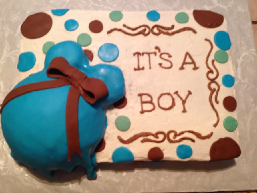 Baby shower cake with a blue baby bump and polka dots